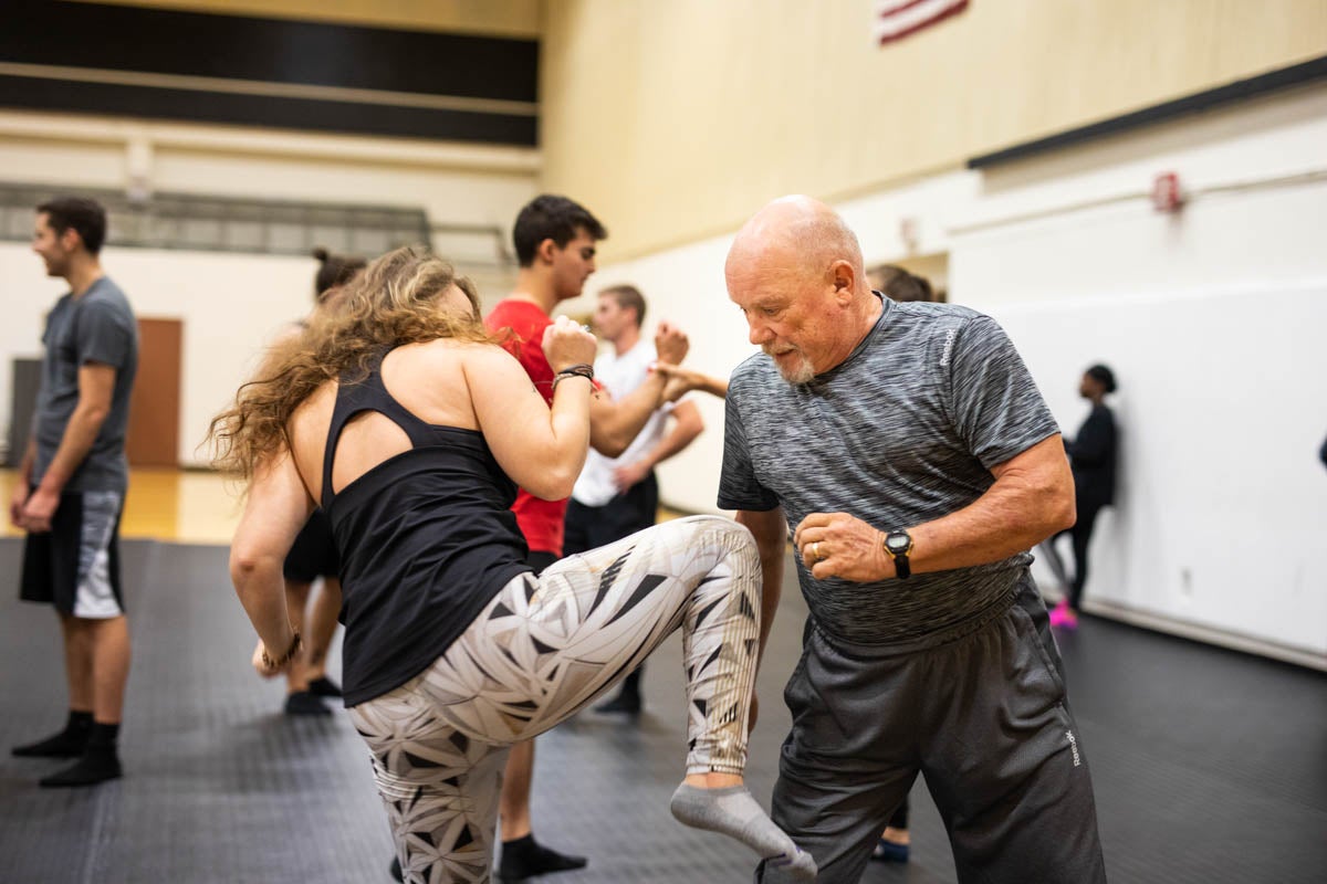 Technical assistant Mark Simpson works with a student to develop proper form during an attack. (Photo by Nick Leyva '15)