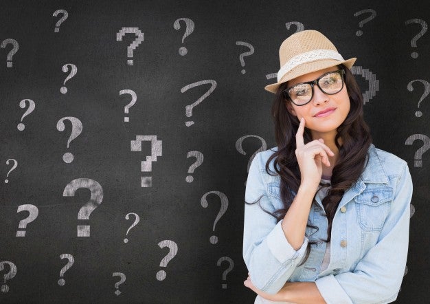 woman with question marks on chalkboard