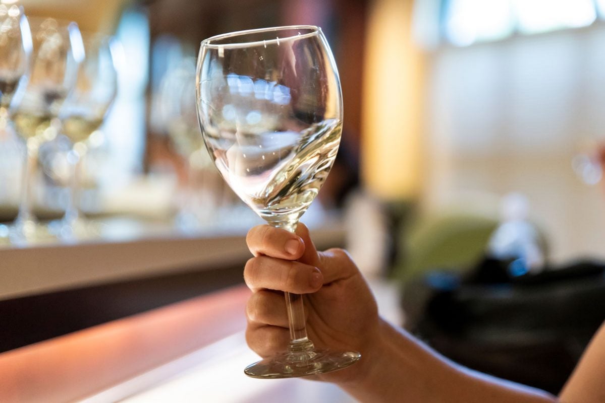 closeup of white wine swirling in a glass