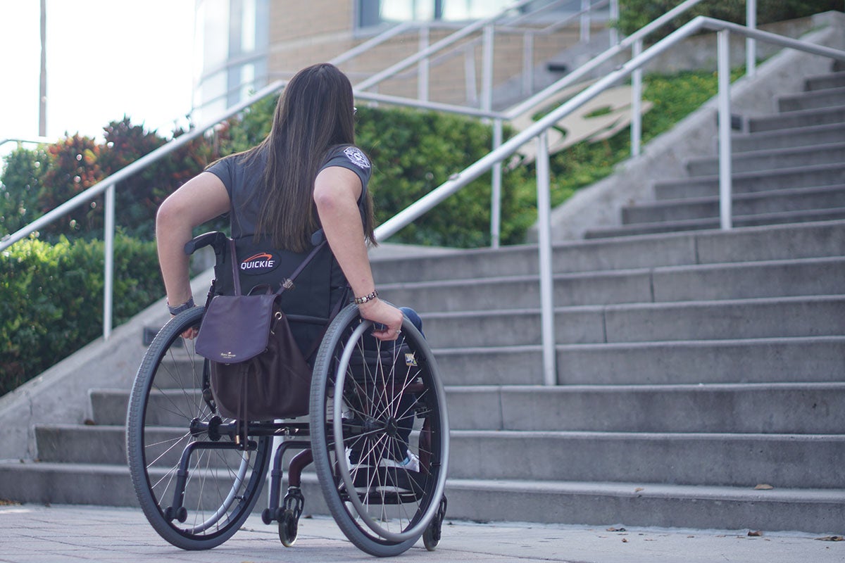 Katherine Torres approaching stairs in her wheelchair.