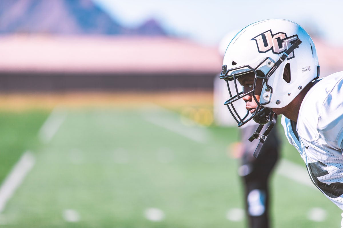 Closeup, side angle of UCF football player wearing white helmet