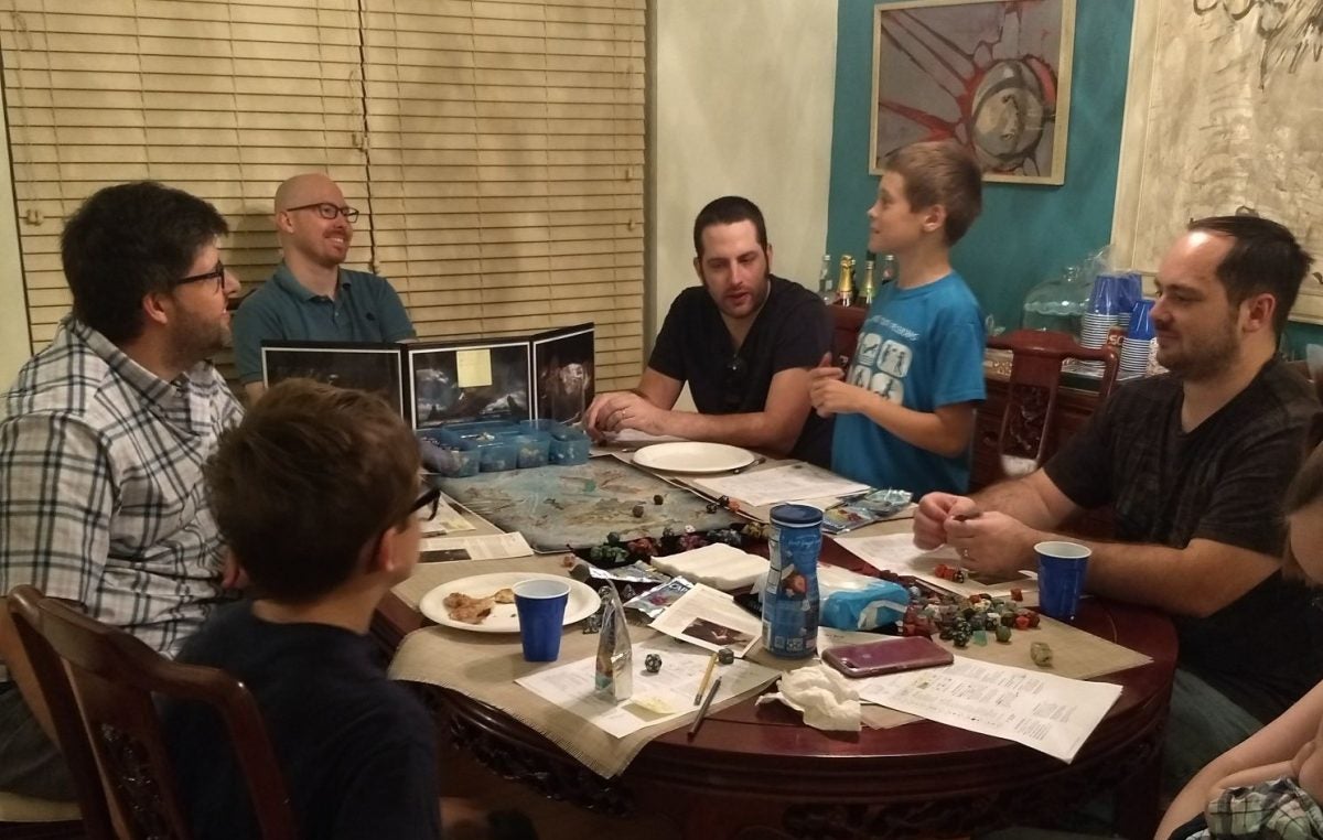 Gamers sitting around a table and playing Dungeons & Dragons