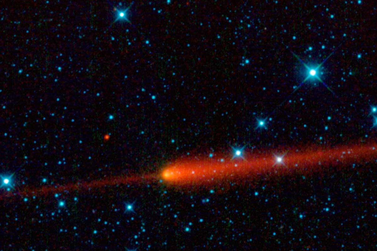 red comet streaks across galaxy