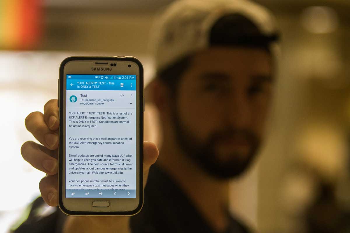 man holding cell phone to display screen