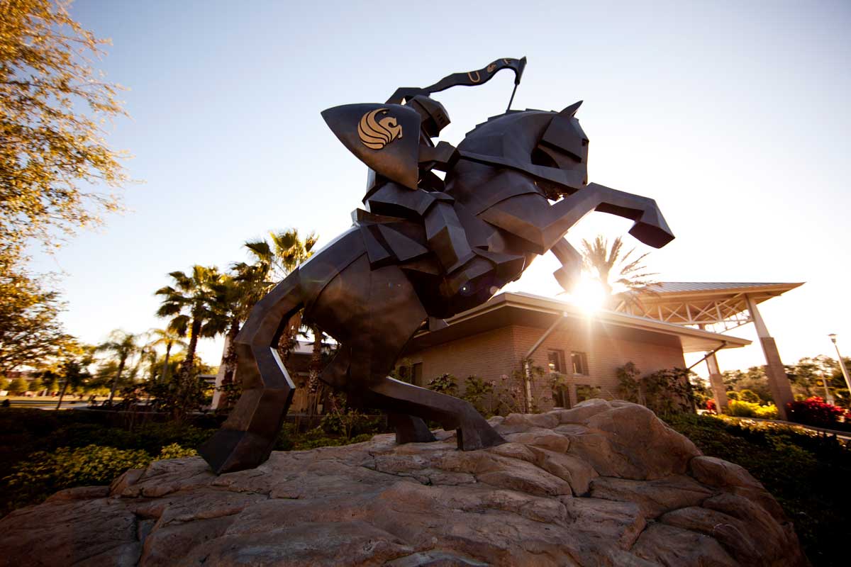 Knight statue with setting sun in the background