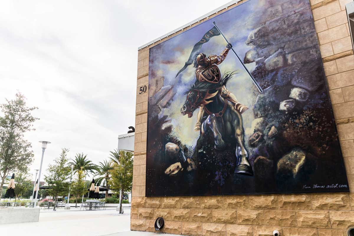 mural of Knight riding a horse and breaking through a brick wall