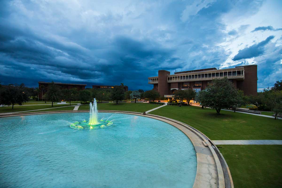 Storm clouds roll in over UCF's Reflecting Pond and John C. Hitt Library
