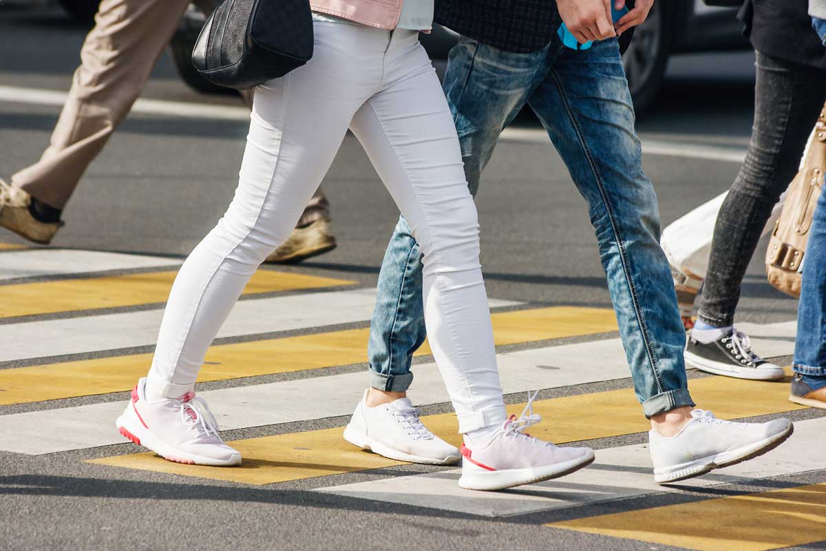 pedestrians use yellow and white crosswalk