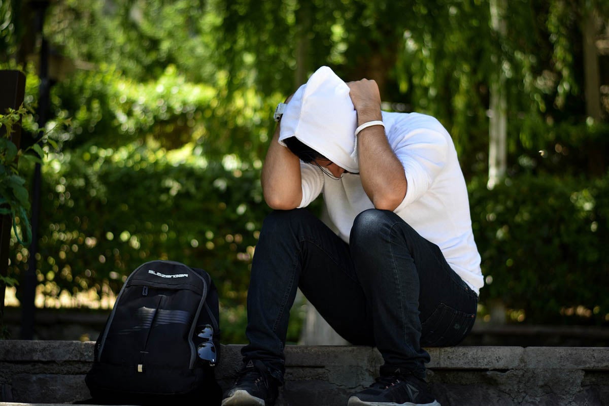 Man with head looking downward.