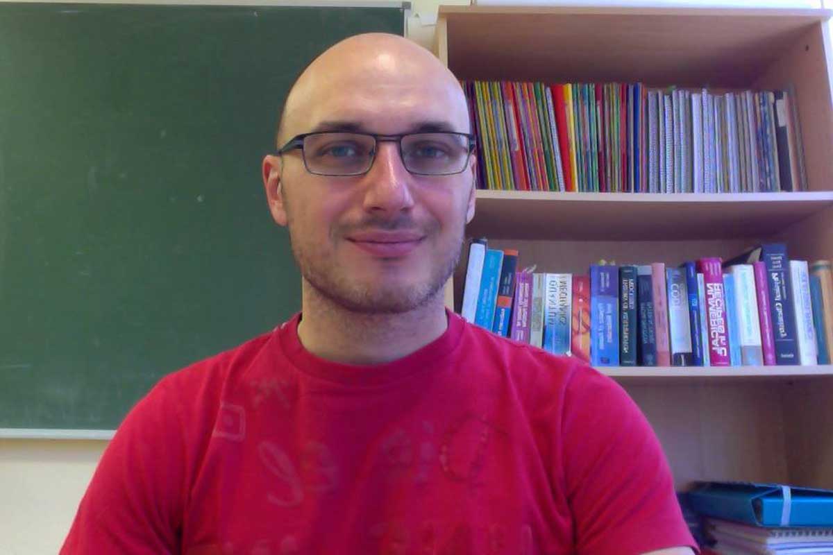 Luca Argenti in a classroom with a bookcase