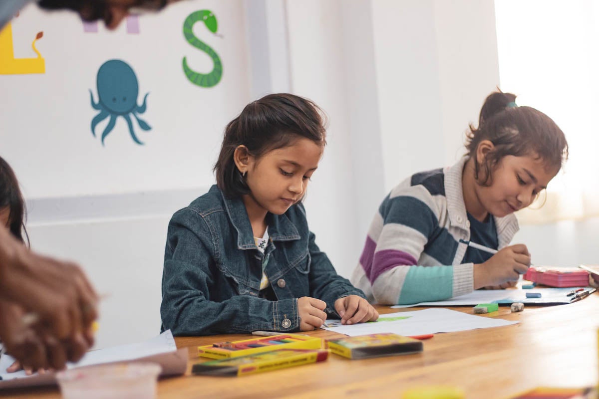 Two girls sitting in classroom