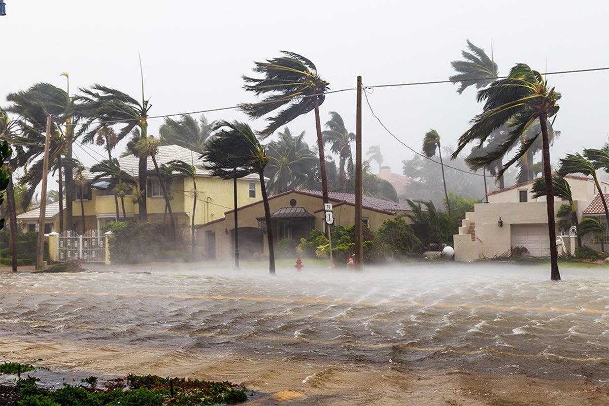 High winds and floods are threatening a residential area.