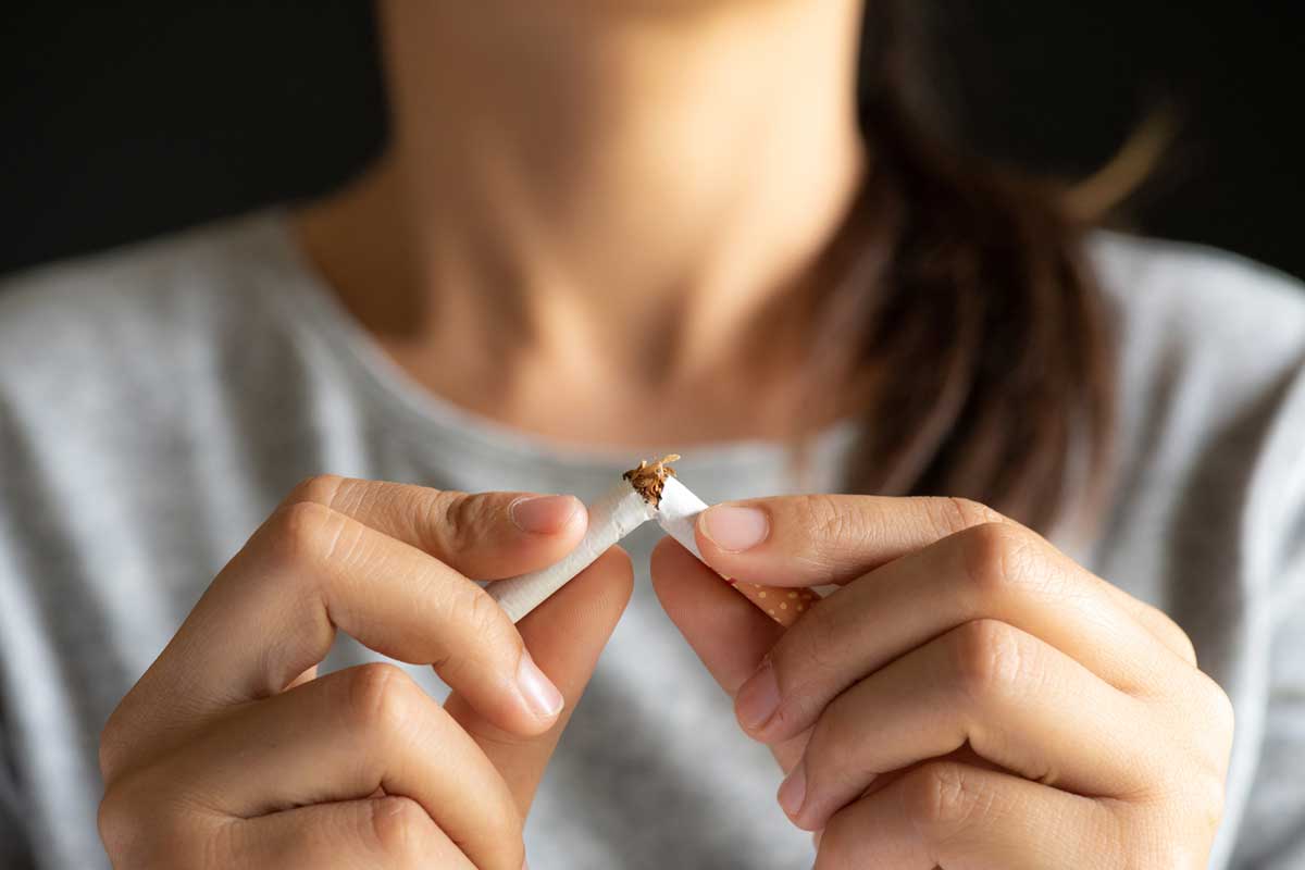 Woman snaps a cigarette