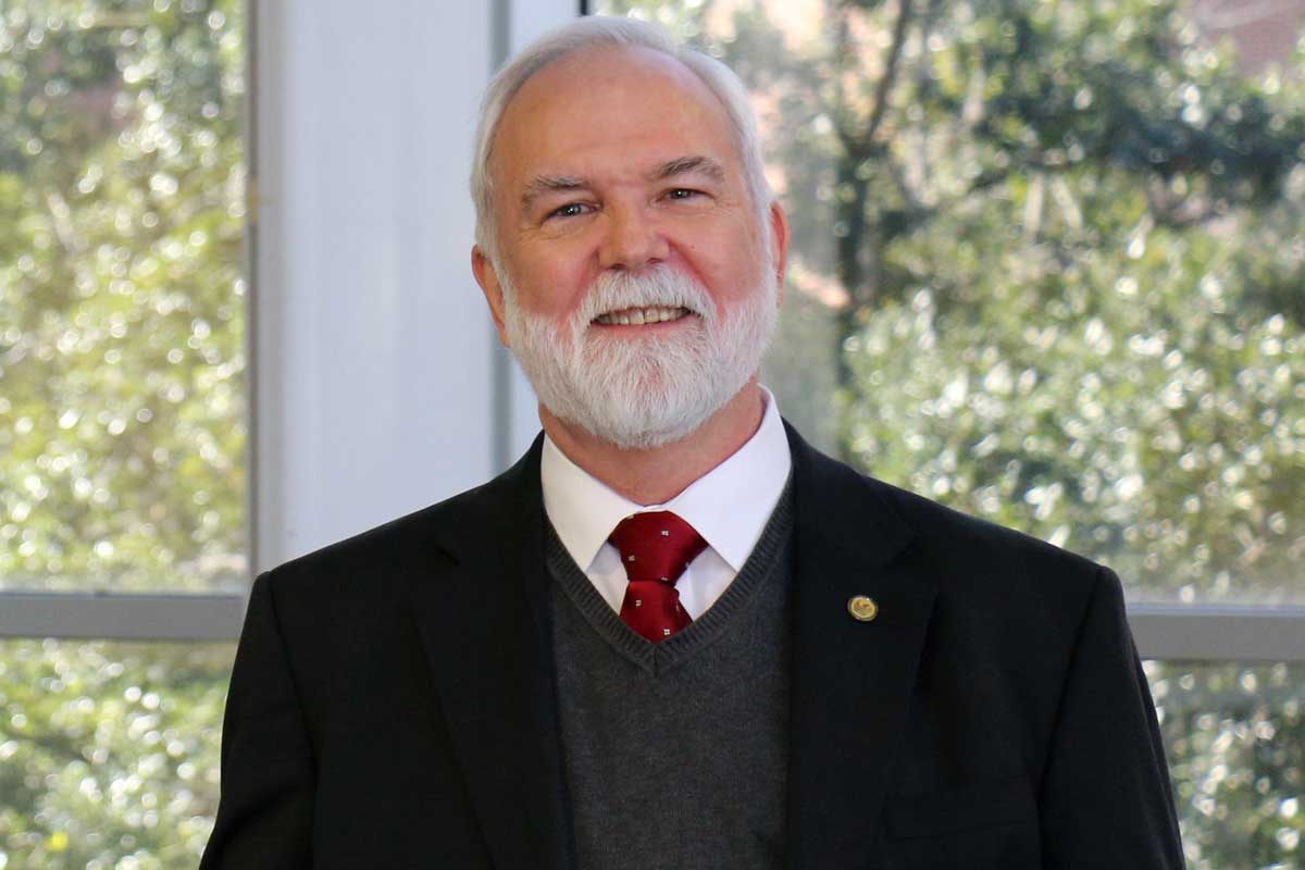 bearded man wearing black business suit