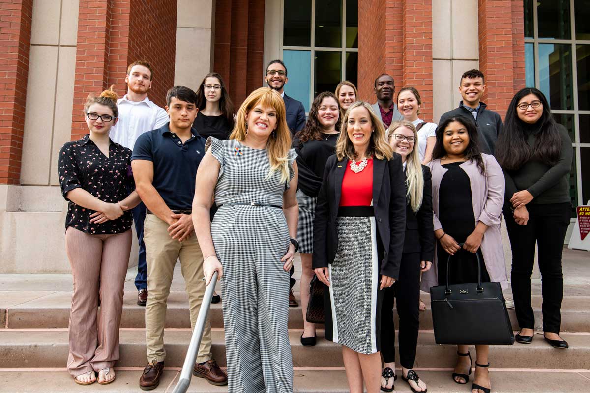 Juleigh Mayfield, Irene Pons and a group of UCF students stand on the steps of a courthouse