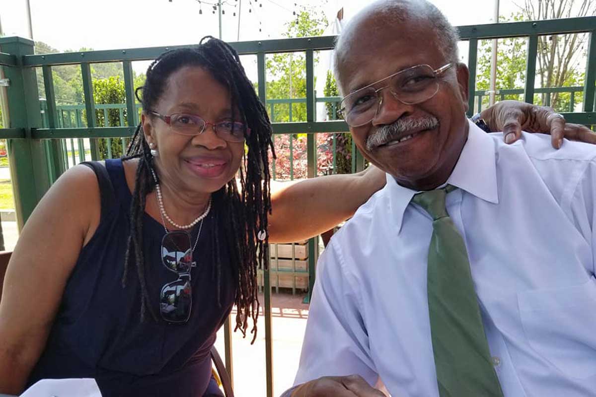 Wiletha and Roland Williams seated outside