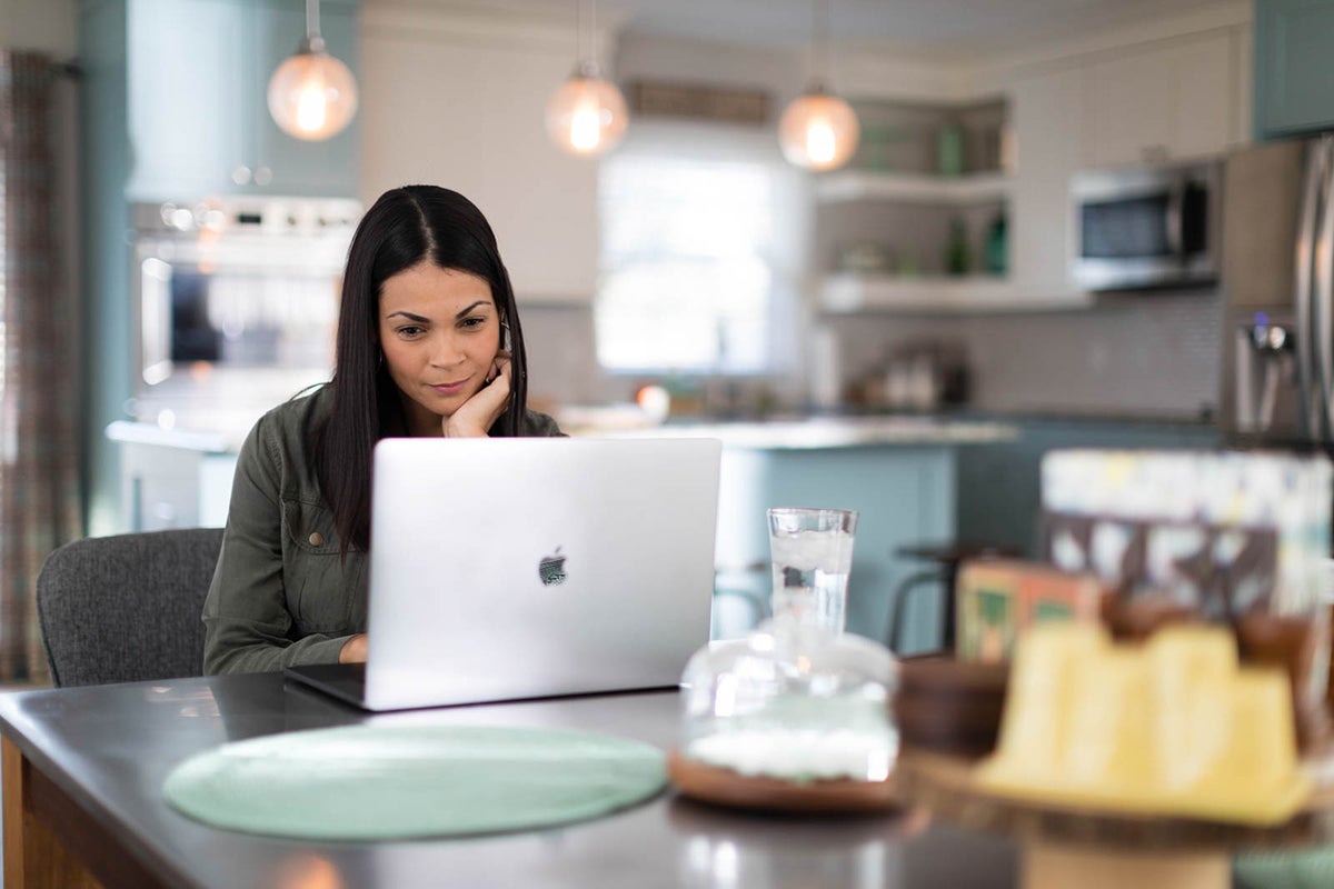 Woman looks at her laptop