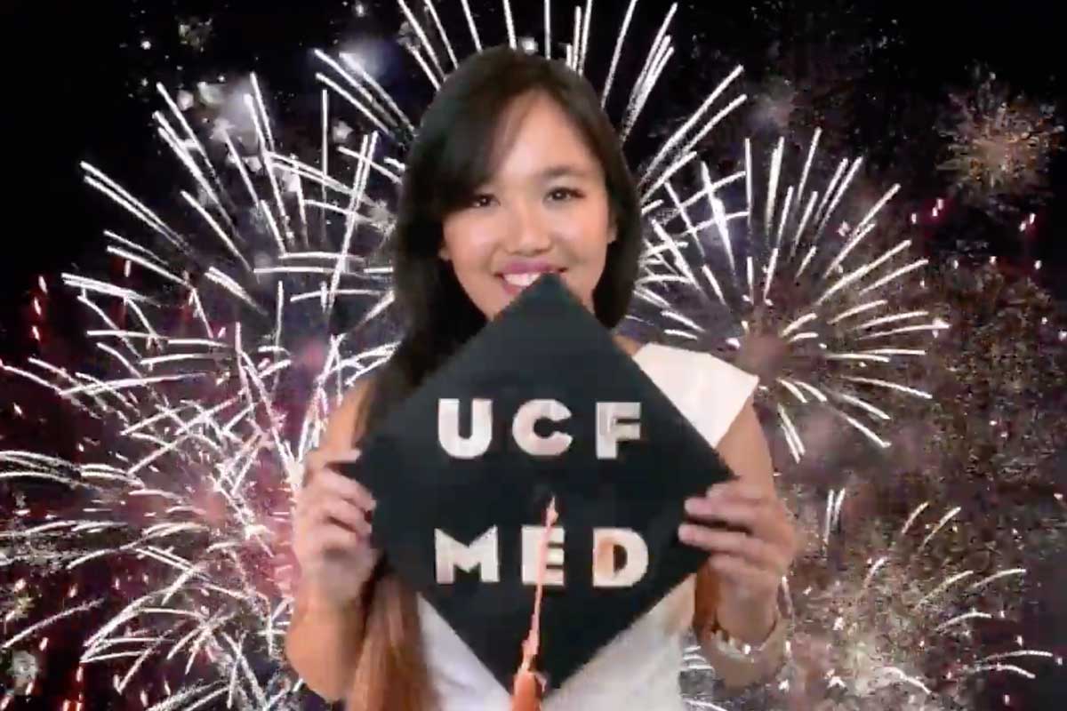 Sonia-Dela-Cruz holds grad cap