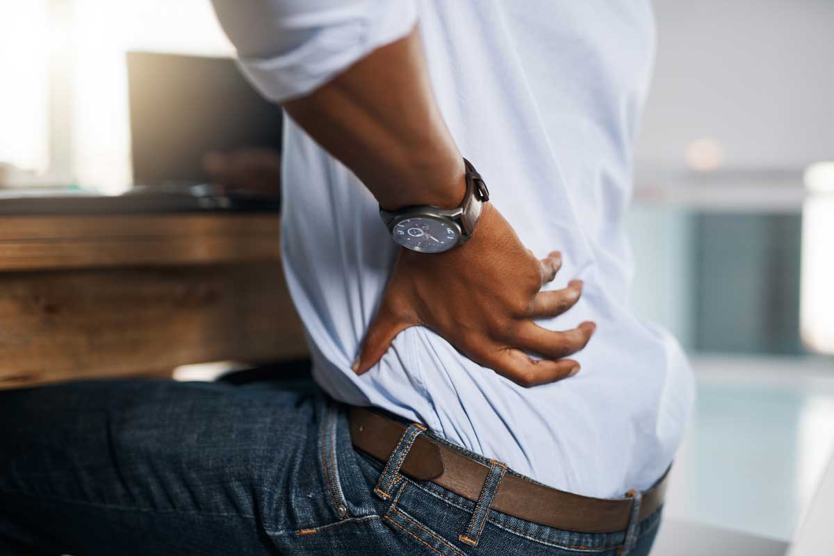 Closeup of man's arm on lower back