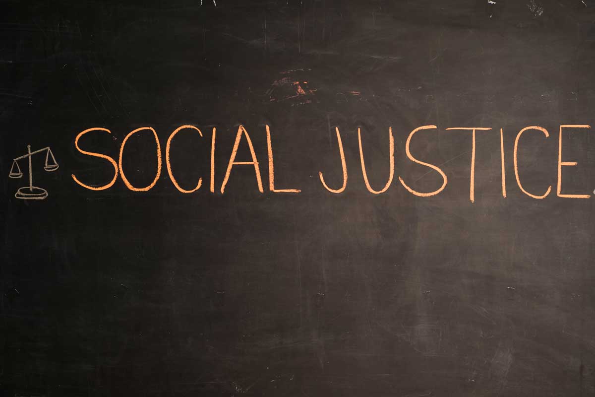 social justice written in chalk on blackboard