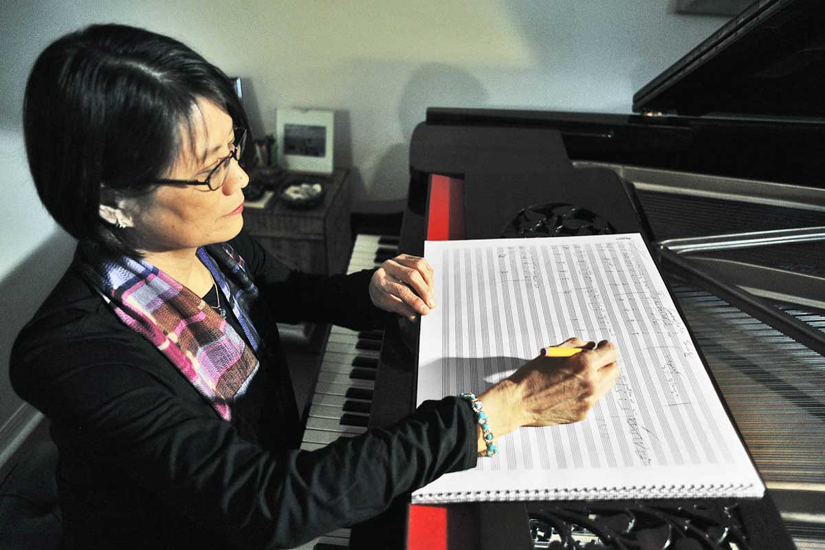 Stella Sung sits at desk to compose