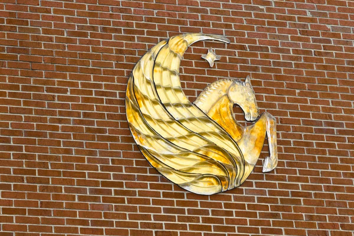 gold Pegasus on brick