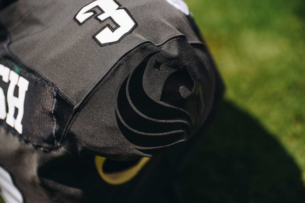 closeup of black football jersey with Pegasus logo