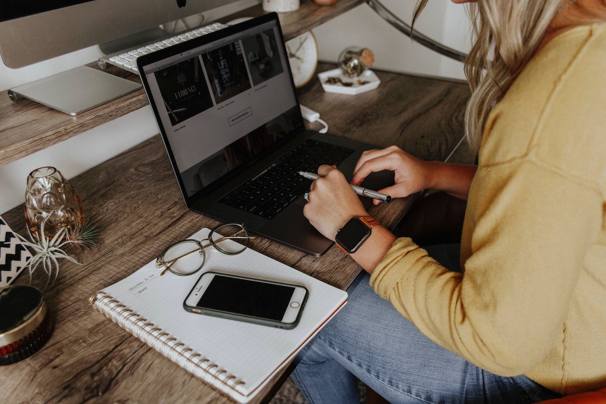 a woman working at a laptop while home