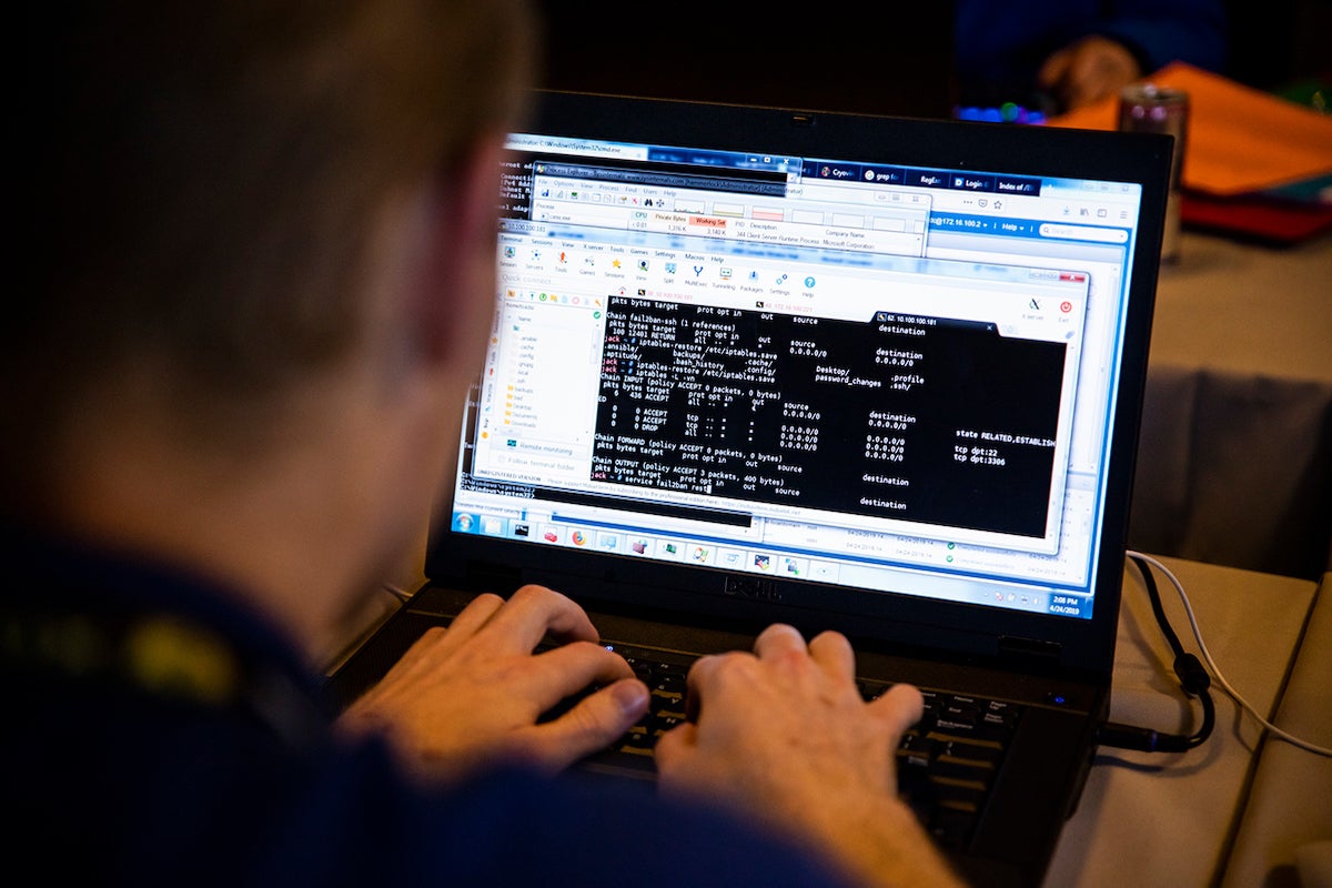 closeup of student coding on a laptop