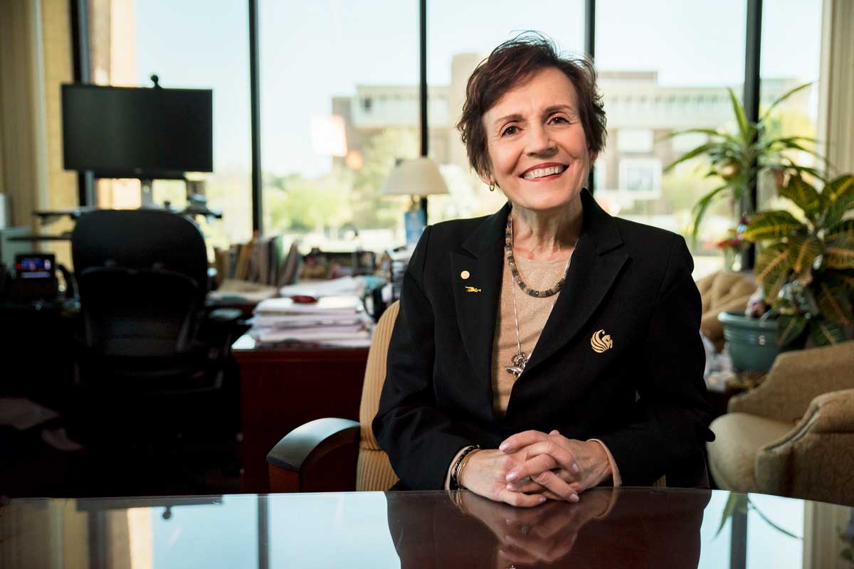 Maribeth Ehasz sits at her desk