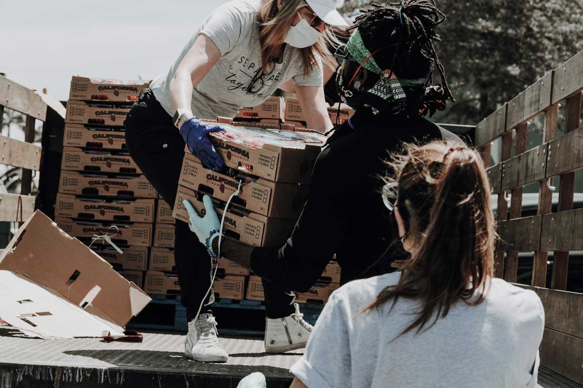People work together to unload crates from truck