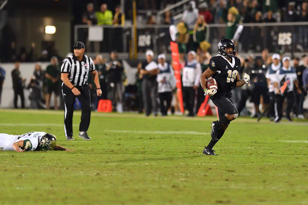 Mike Hughes breaks free as USF player lays on field