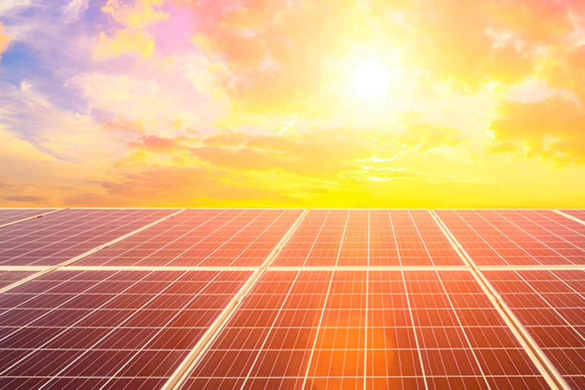 solar energy panels with sun shining above them