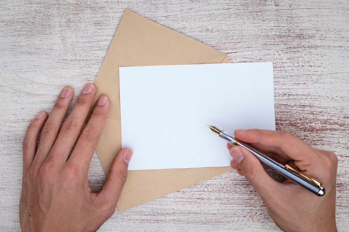 Someone preparing to write a letter