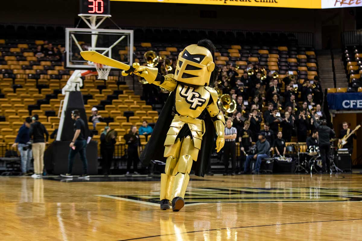 Knightro points his sword on basketball court