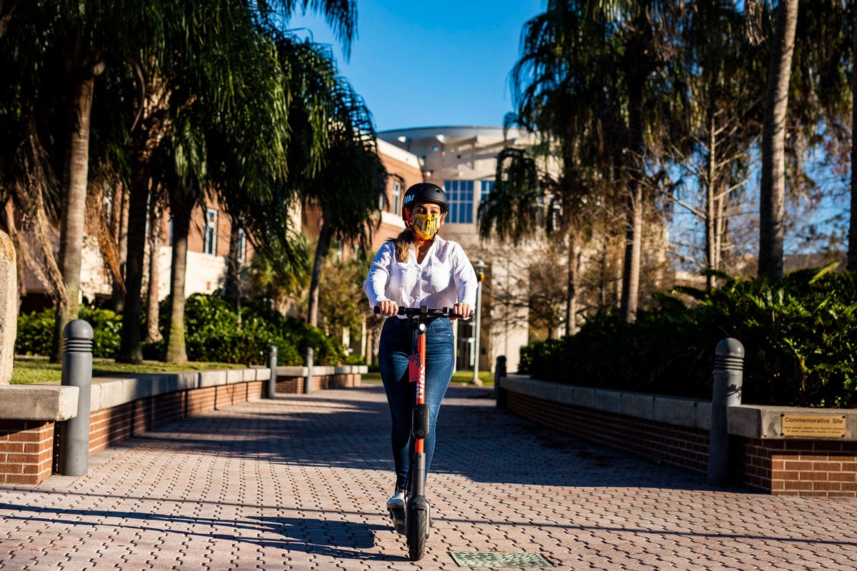 Student rides Spin Scooter on Memory Mall