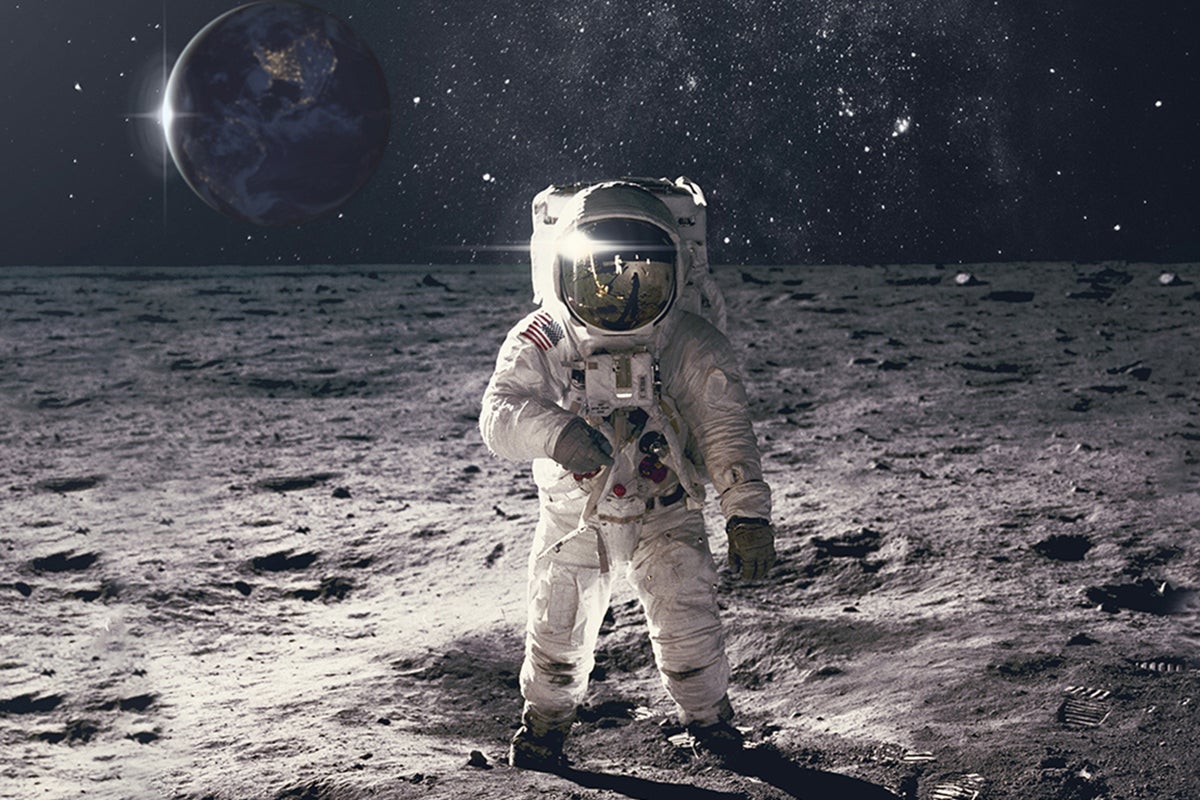 Astronaut on the moon looking at camera with Earth in background