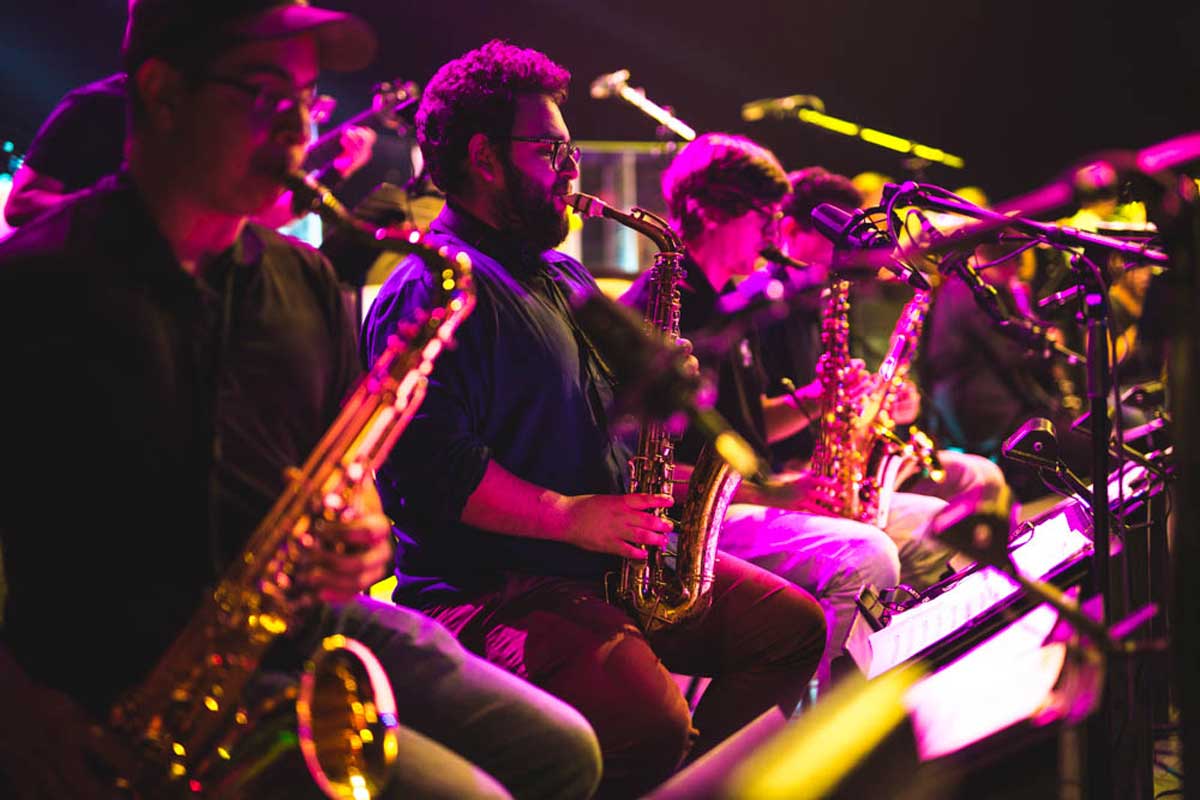 Jazz musicians glow in purple lighting