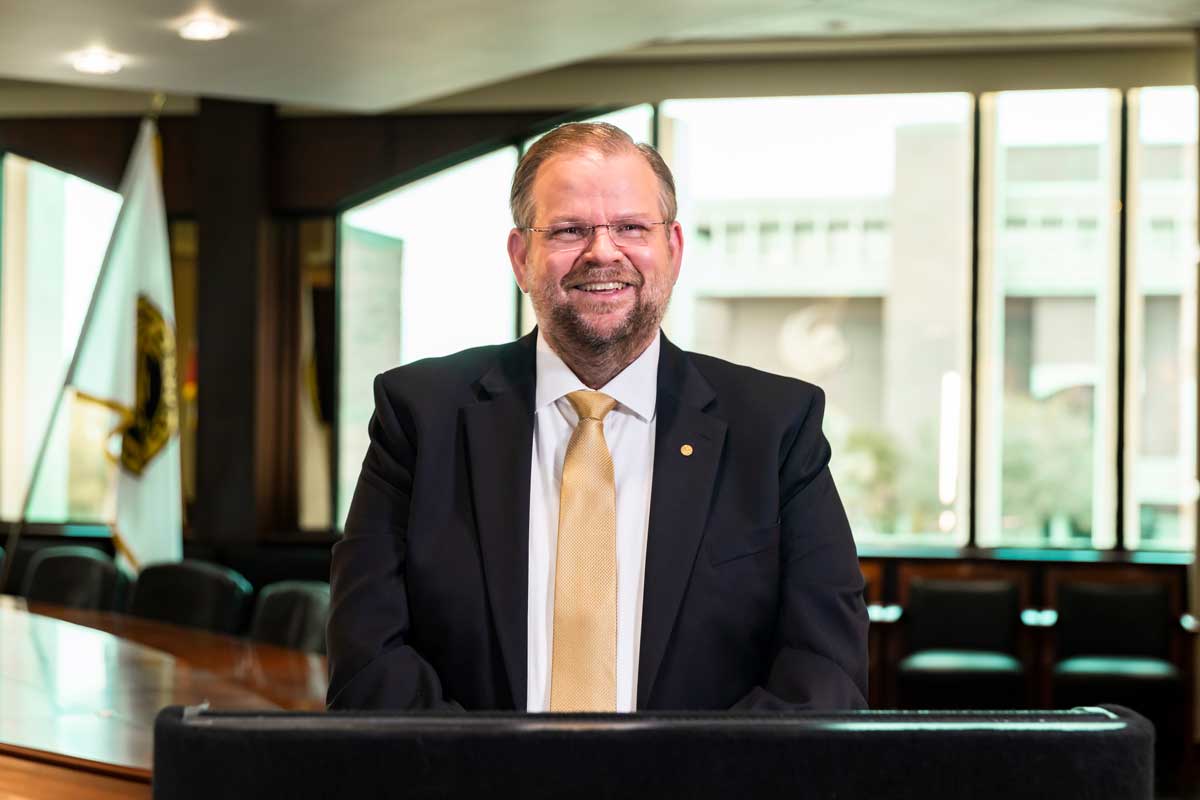 President of UCF, Alexander N. Cartwright, stands at a podium in Millican Hall