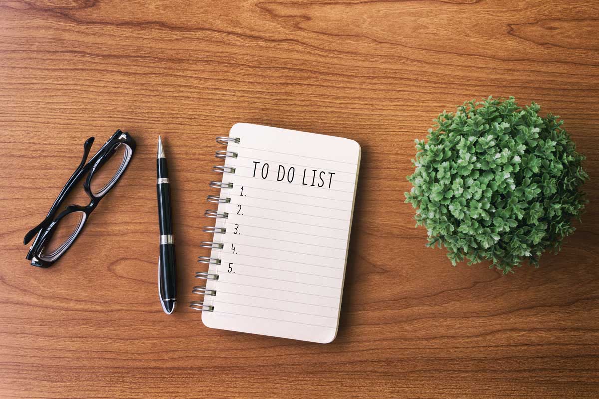 Directly above view of office desk with Notepad and text - To do list.