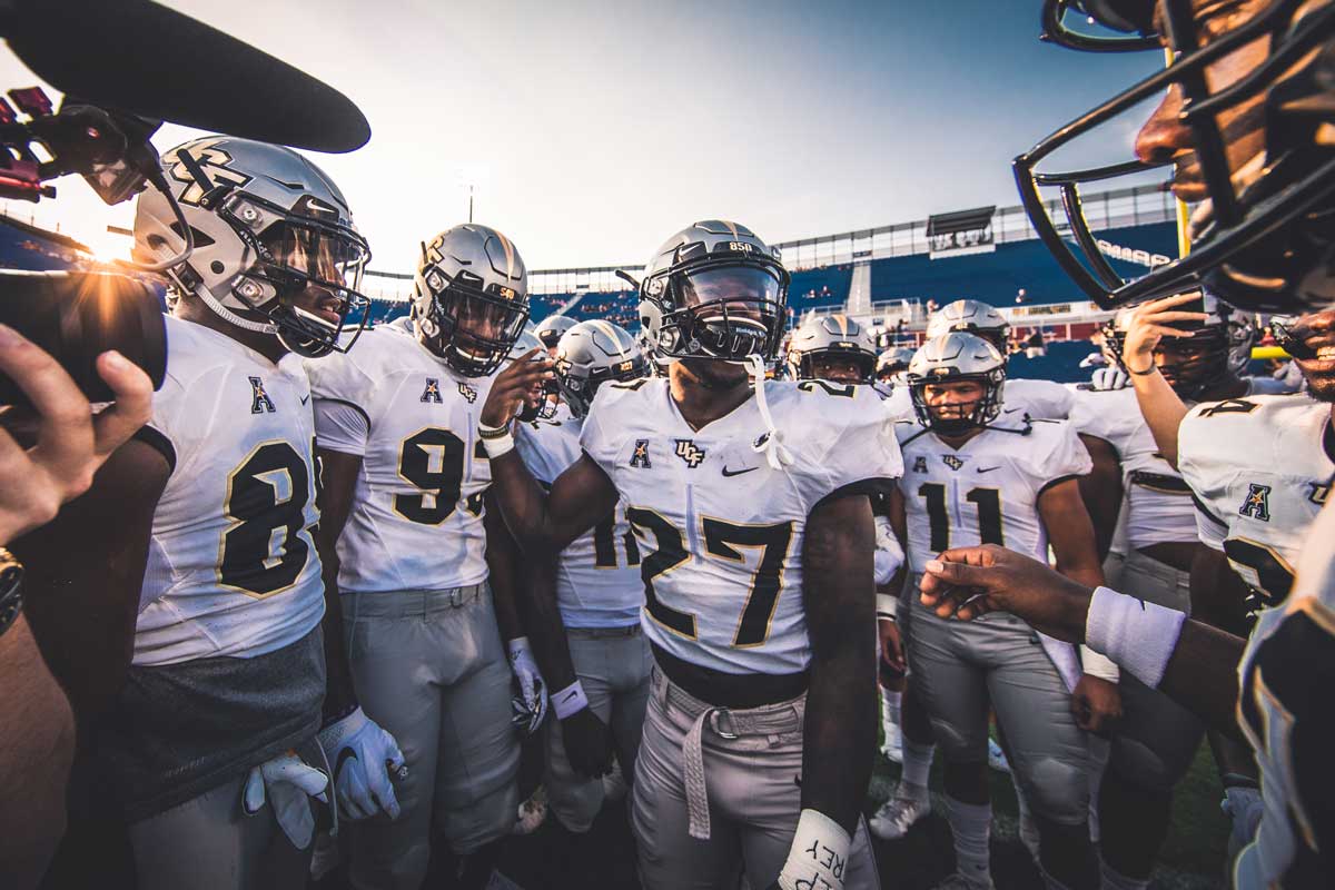 Richie Grant (#27) in middle of huddle