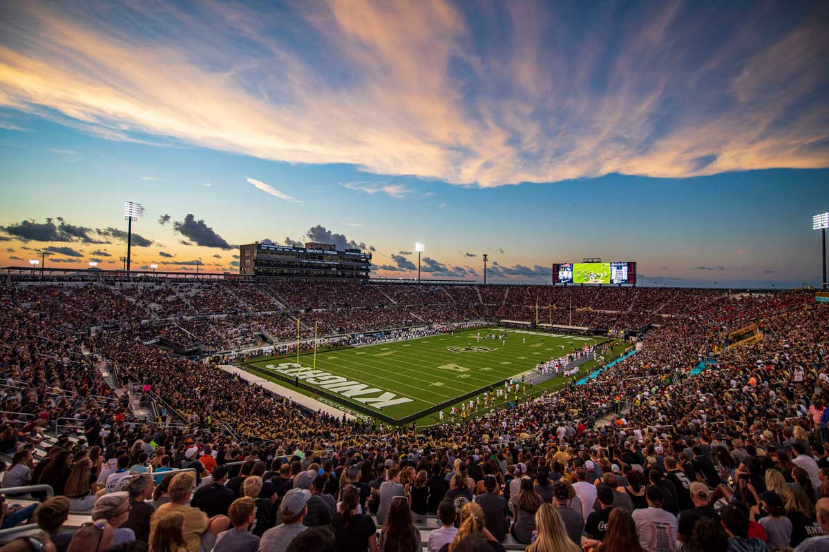 Football stadium at full capacity as sun sets