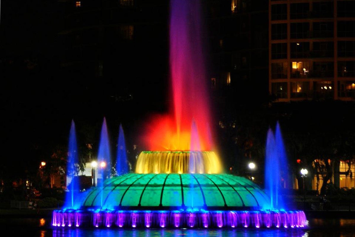 Lake Eola lit up in rainbow colors at night