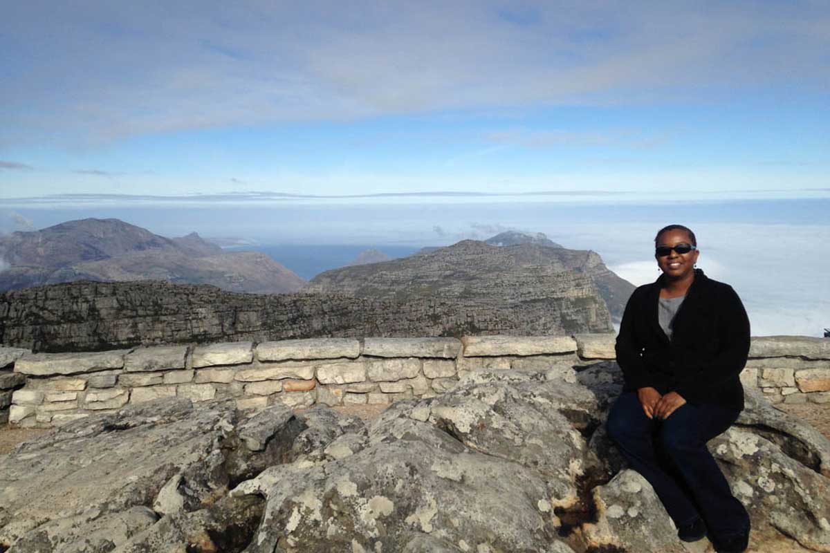 J. Richelle Joe sitting on Table Rock in South Africa.