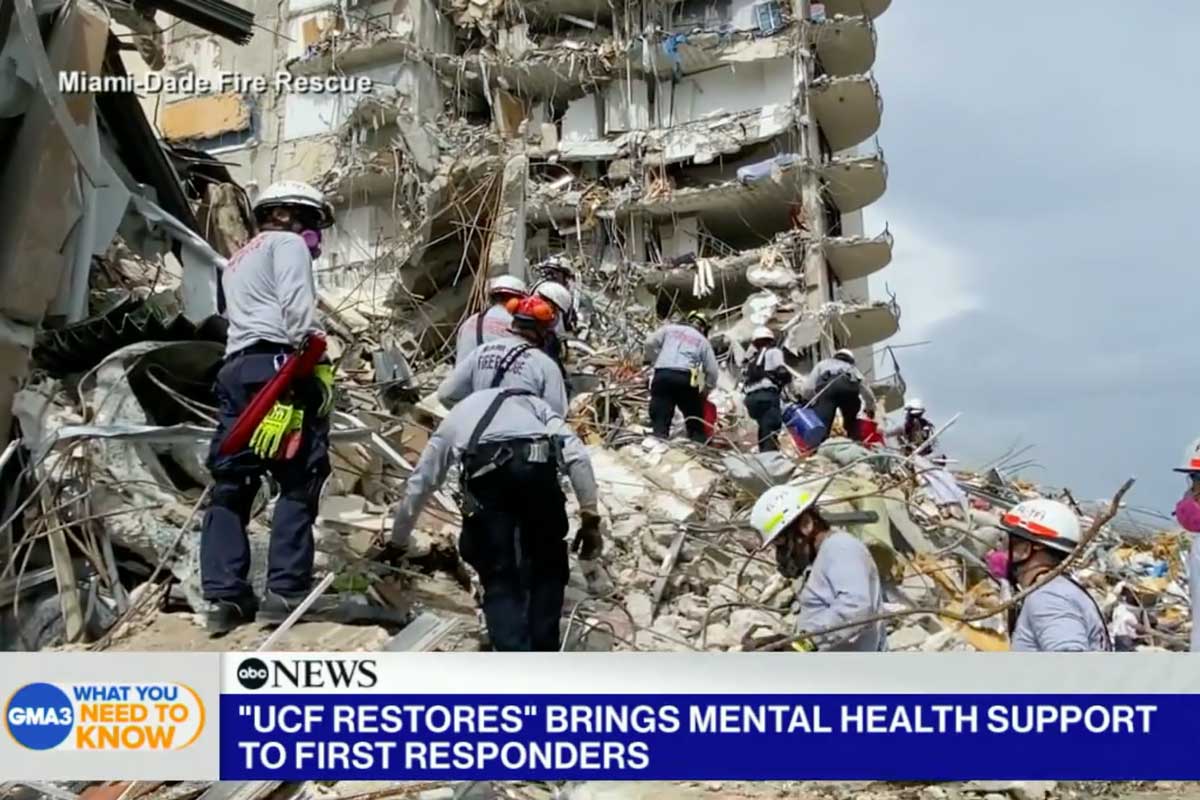 First responders stand on piles of rubble at Miami condo collapse site
