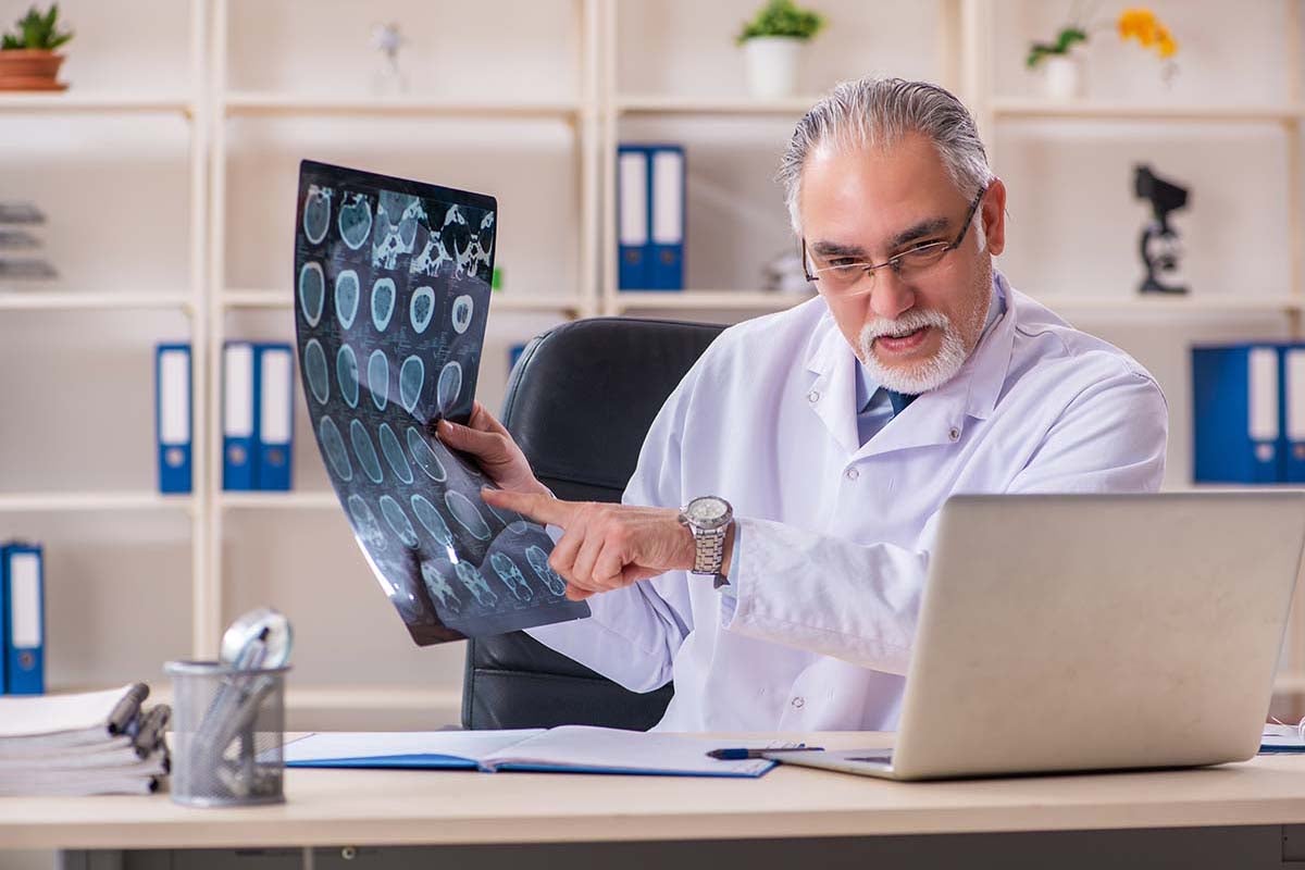 a doctor talking about x-rays to someone through a computer