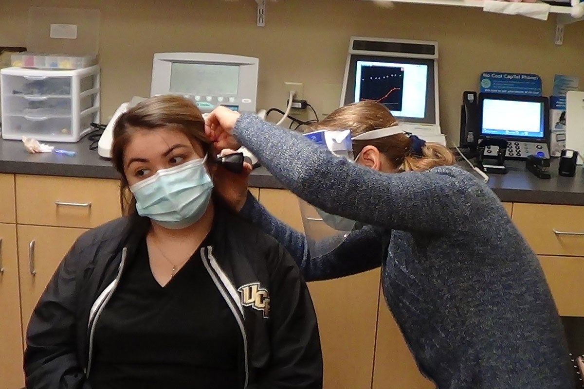 Selena Lopez gets her hearing checked by UCF faculty member