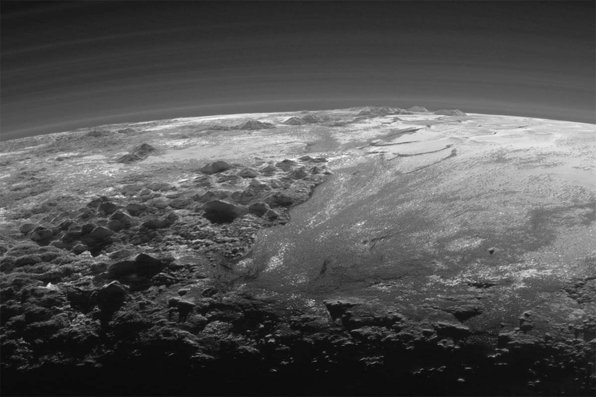 Pluto's majestic mountains and frozen plains are pictured