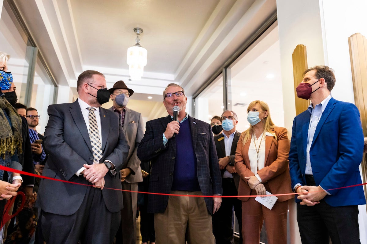 President of UCF, Alexander N. Cartwright (left), joins Orlando Mayor Buddy Dyer (center), partners and community members for the ribbon-cutting ceremony for the new downtown entrepreneur hub.