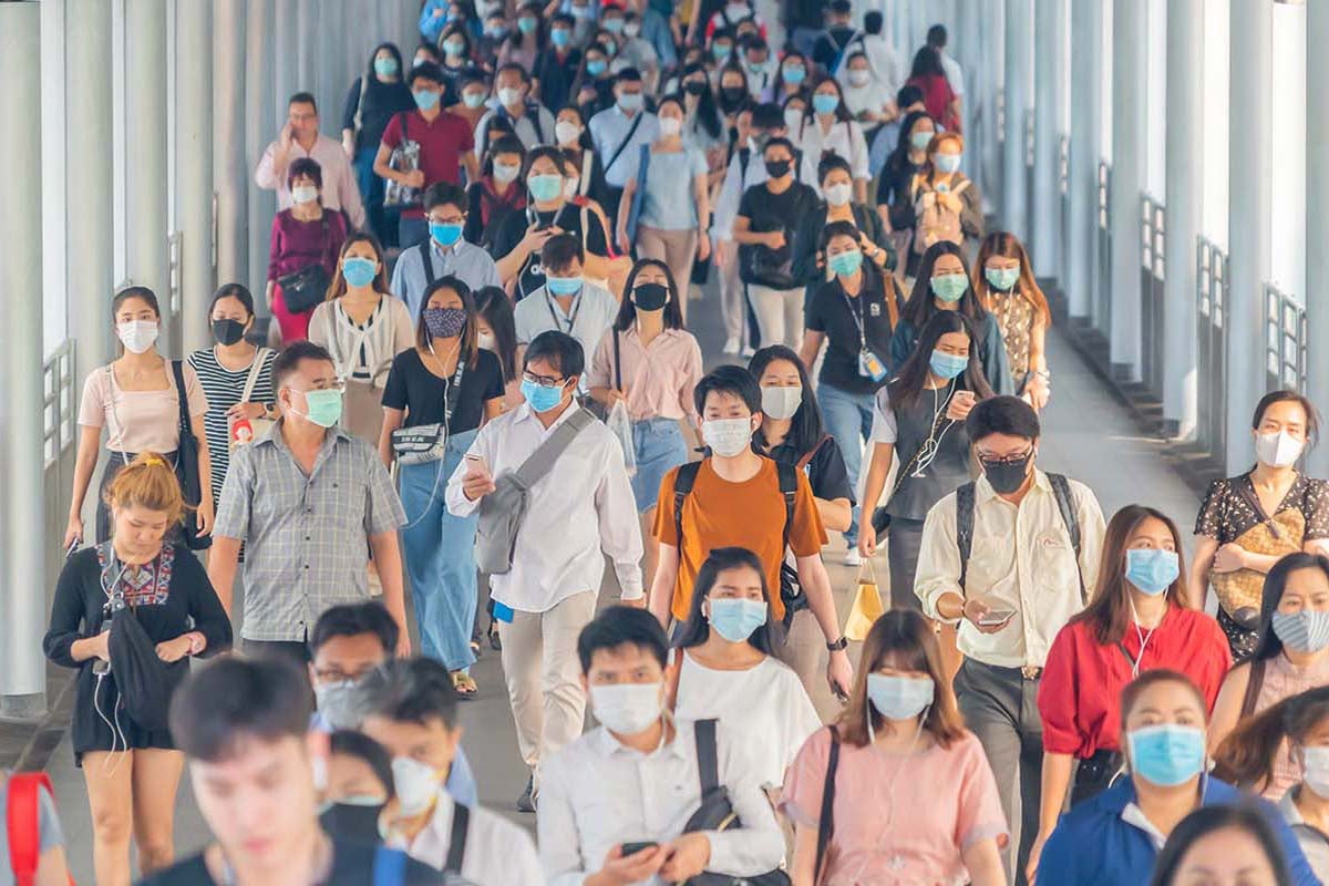 people wearing face masks in a crowd